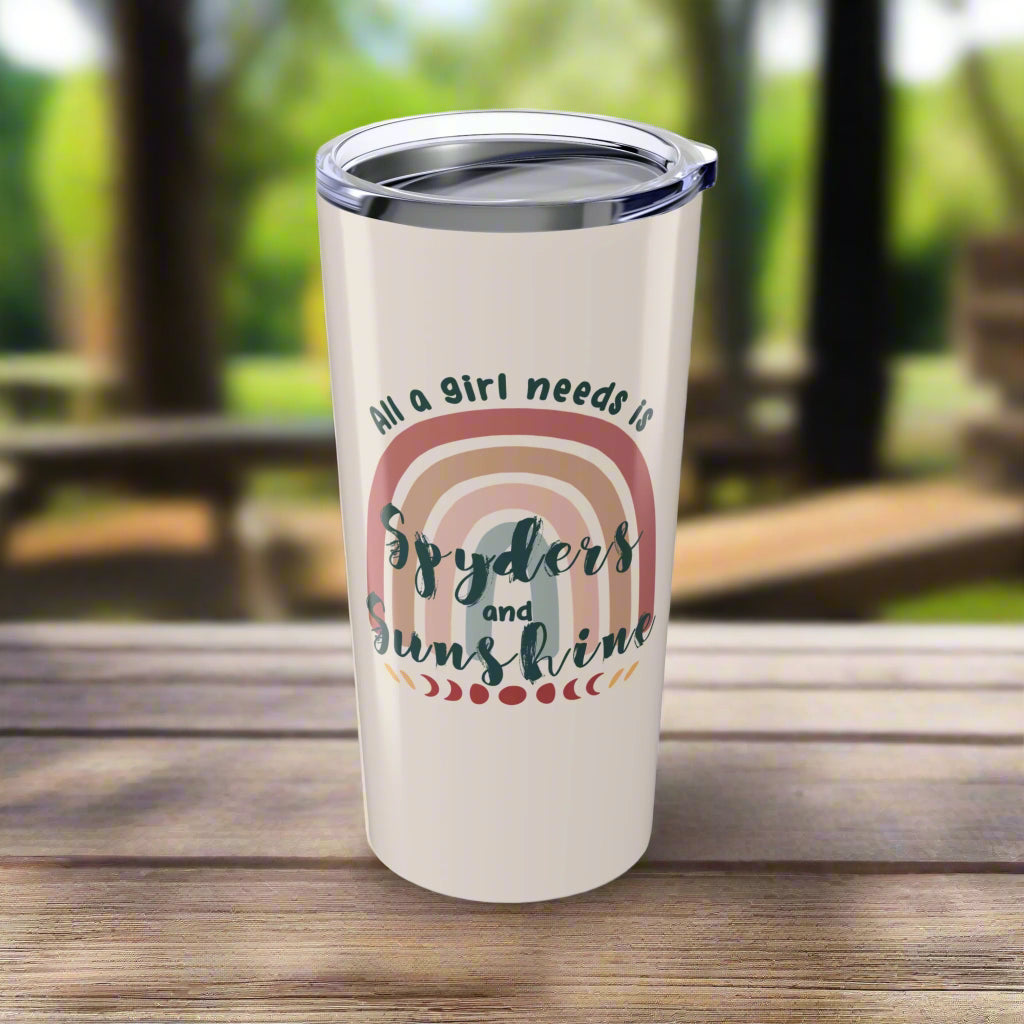 Tumbler with rainbow design and text on a white background