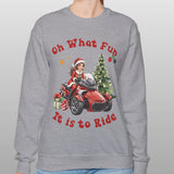 Person wearing a gray sweatshirt with a Christmas-themed design and text.