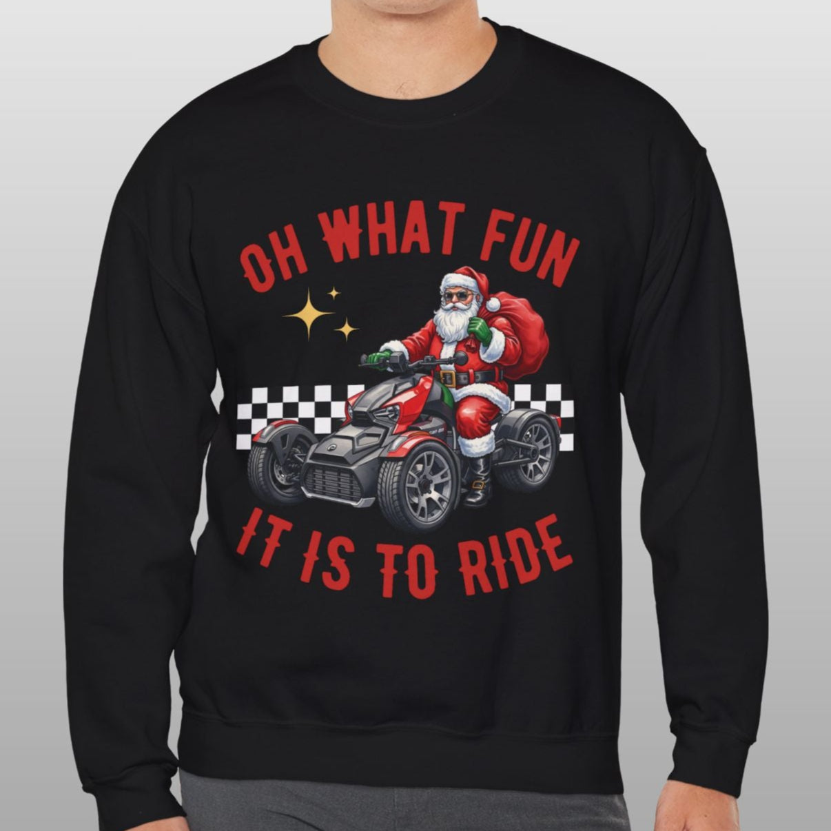 Person wearing a black sweatshirt with Santa Claus graphic and text on a gray background