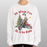 Person wearing a white sweatshirt with Christmas-themed design and text.