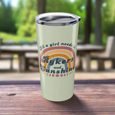 Tumbler with rainbow design and text on a white background