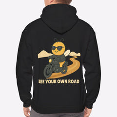Person wearing a black hoodie with a bee graphic and text on the back, on a white background