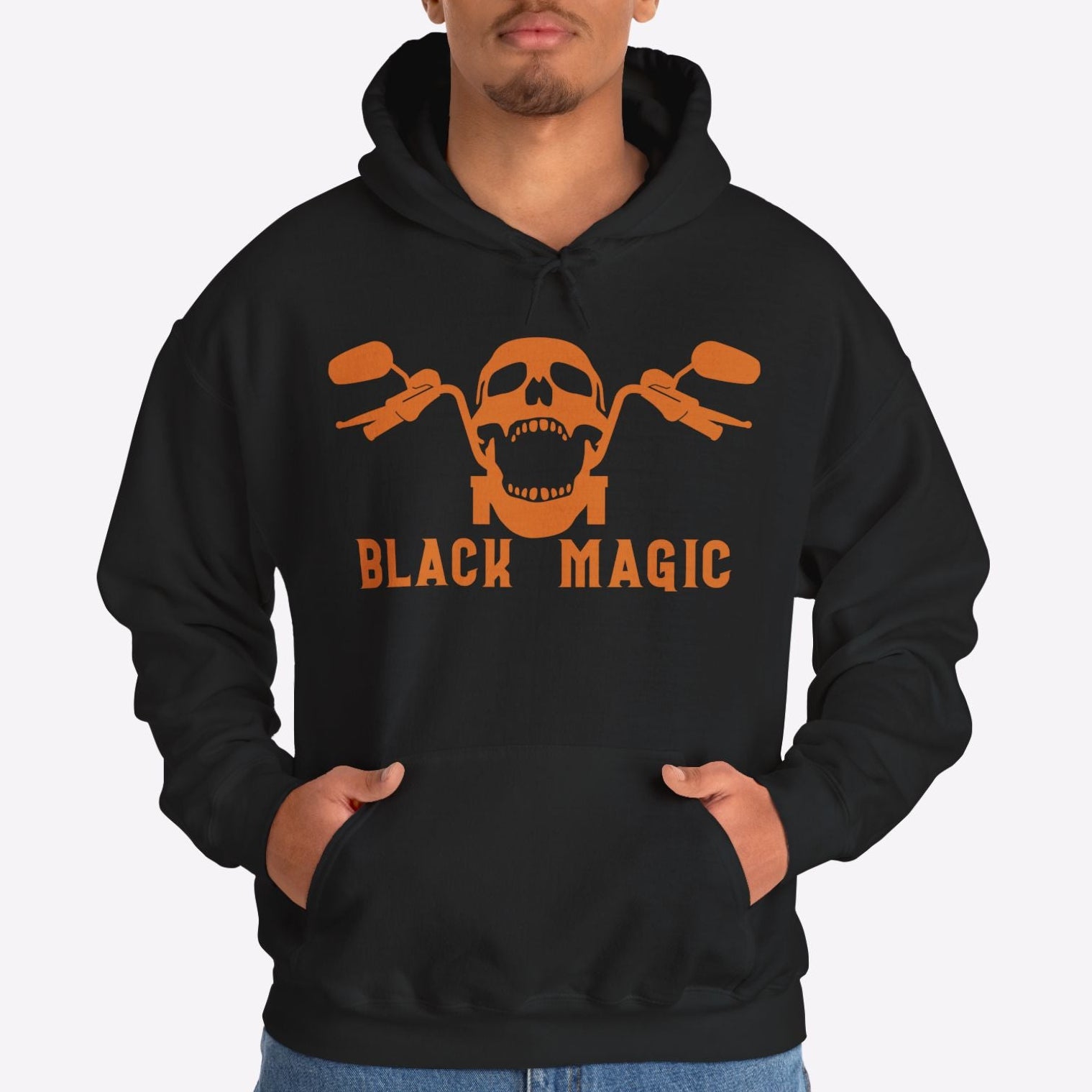 Person wearing a black hoodie with a skull and crossbones design and 'Black Magic' text on a white background
