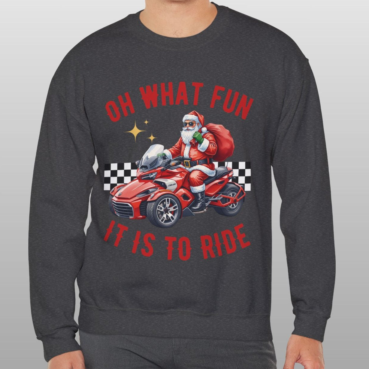 Person wearing a dark gray sweatshirt with a festive design of Santa Claus on a motorcycle and text.