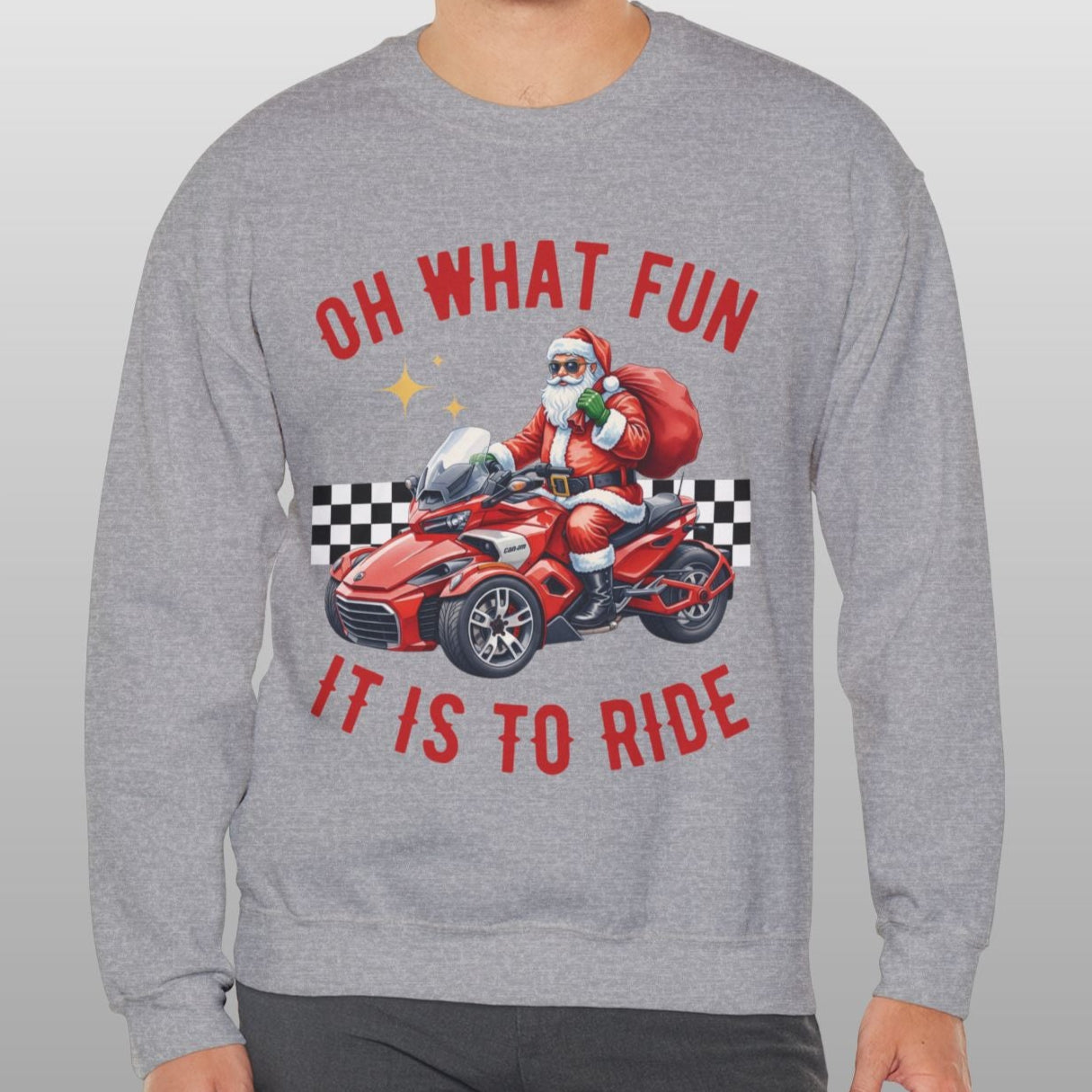 Person wearing a gray sweatshirt with Santa Claus on a motorcycle graphic and text.