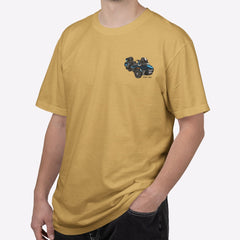 Man wearing a mustard yellow t-shirt with a logo on a white background