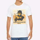 Man wearing a white t-shirt with a graphic design of a bear on a motorcycle.
