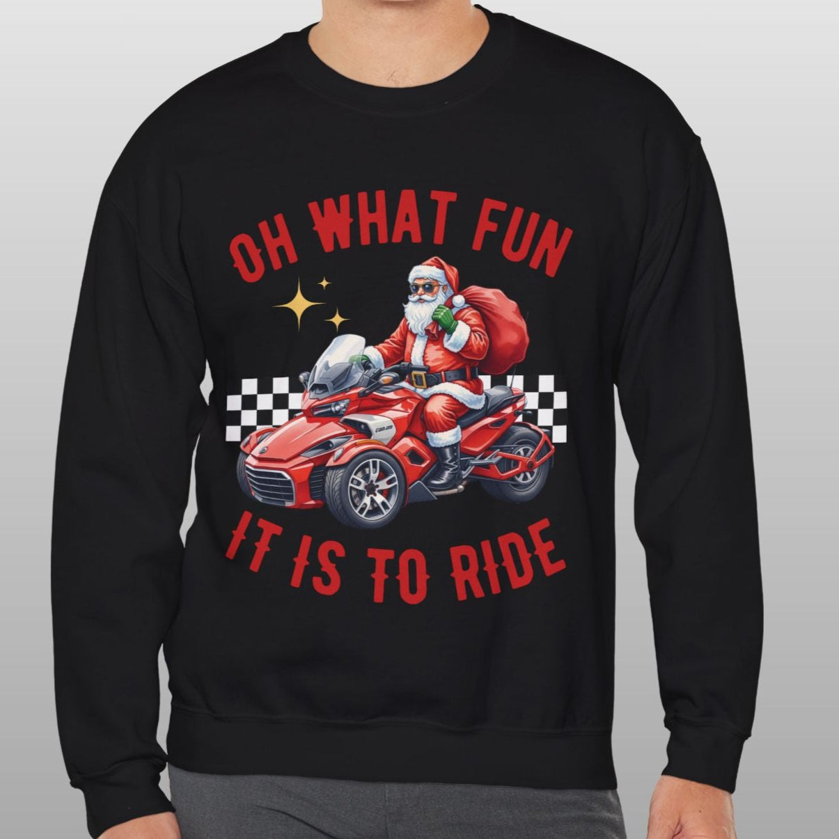 Person wearing a black sweatshirt with Santa Claus in a car graphic and text on a gray background