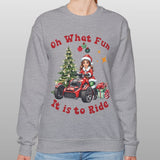 Person wearing a gray sweatshirt with Christmas-themed design and text.