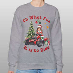Person wearing a gray sweatshirt with Christmas-themed design and text.