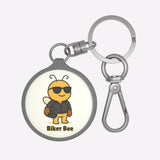 Keychain with a cartoon bee wearing sunglasses and a helmet, labeled 'Biker Bee', on a white background.