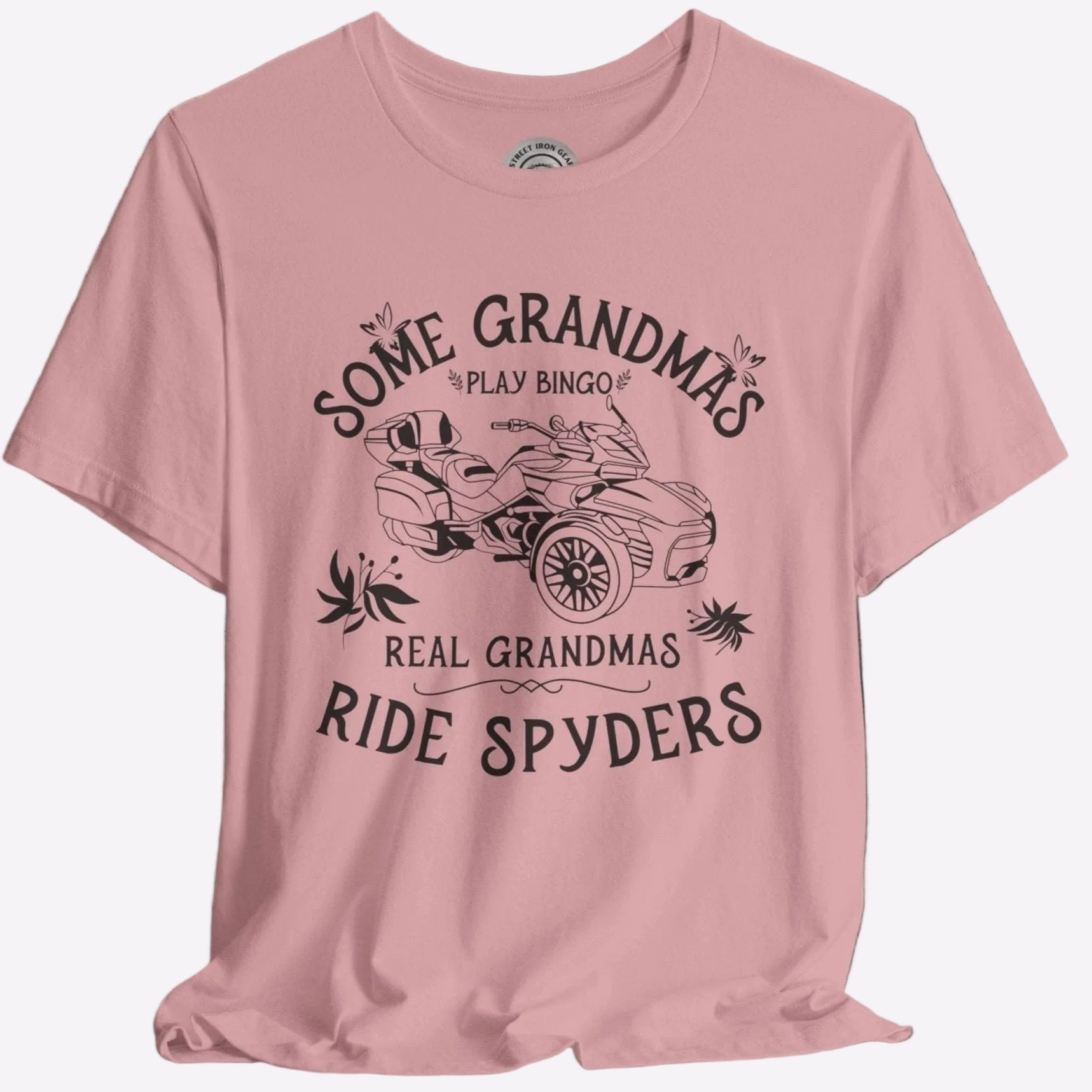 A pink crew neck t-shirt with a graphic print that reads 'Some Grandmas play bingo. Real Grandmas ride Spyders' and depicts a motorcycle.