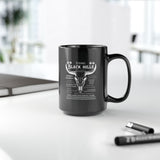 Black mug with white text and design on a white surface