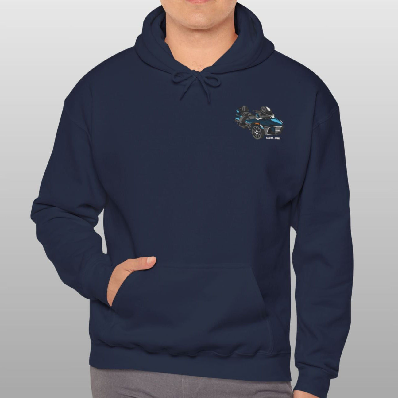 Man wearing a navy blue hoodie with a logo on a gray background