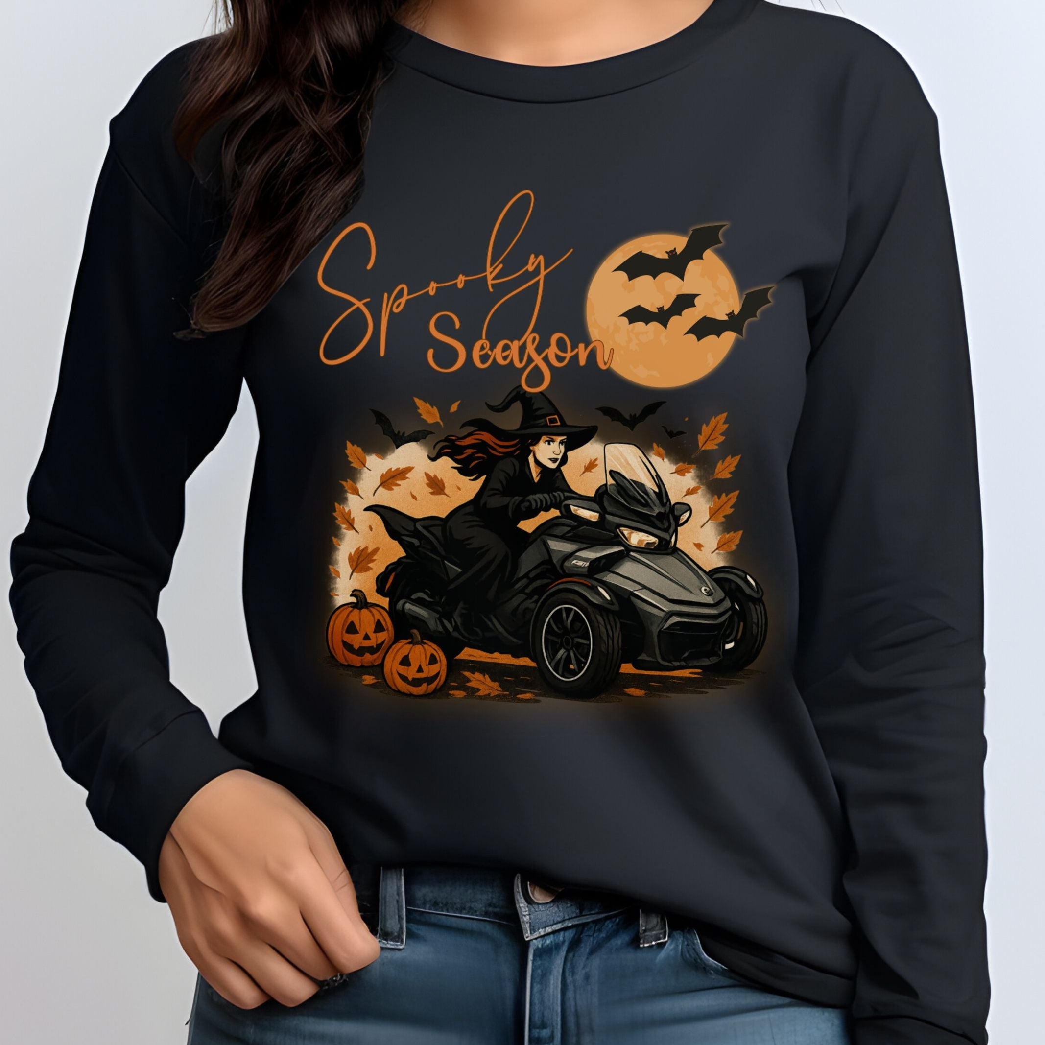 Black sweatshirt with Halloween-themed design featuring a witch, pumpkins, and text on a plain background.
