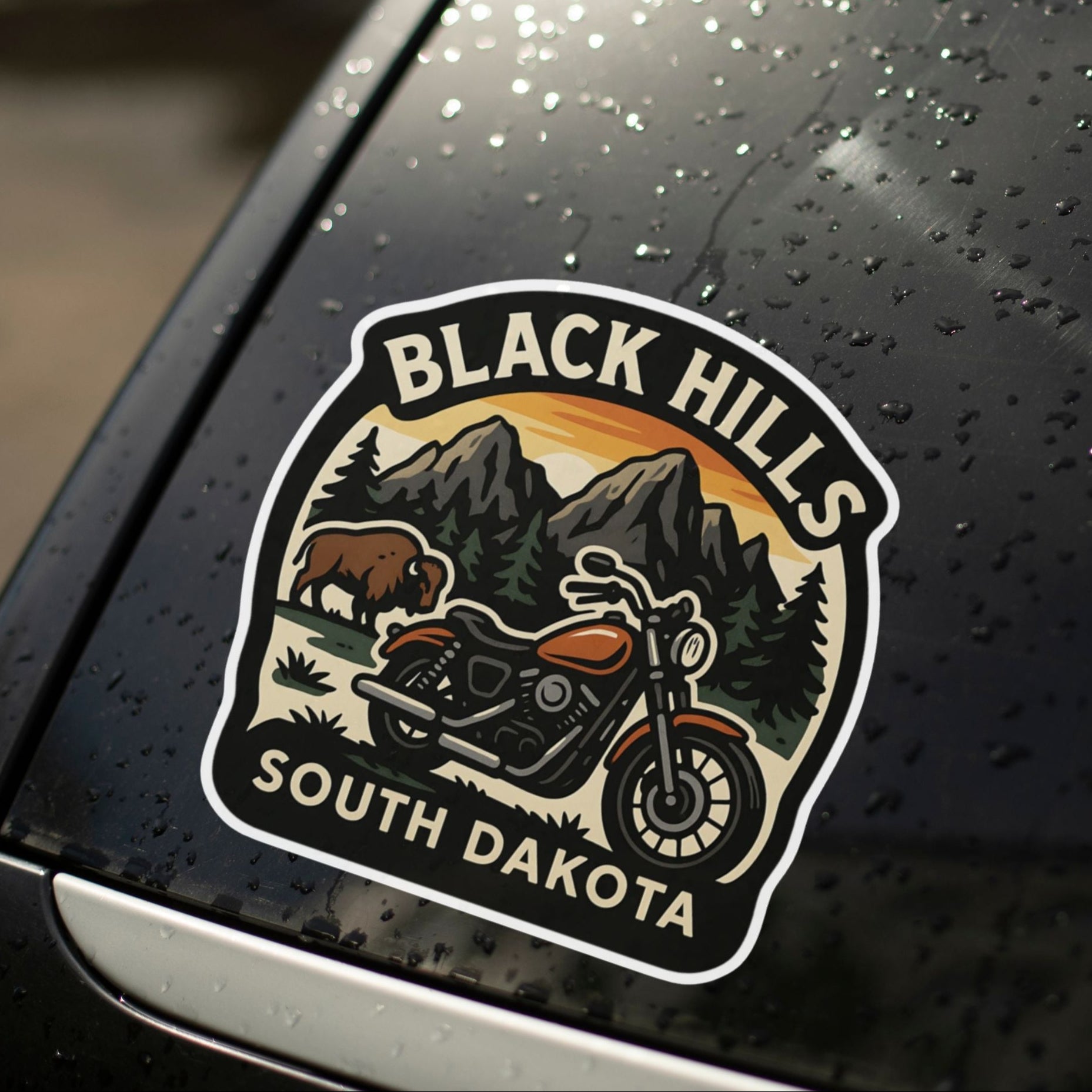 Decal of Black Hills, South Dakota on a car window with raindrops.
