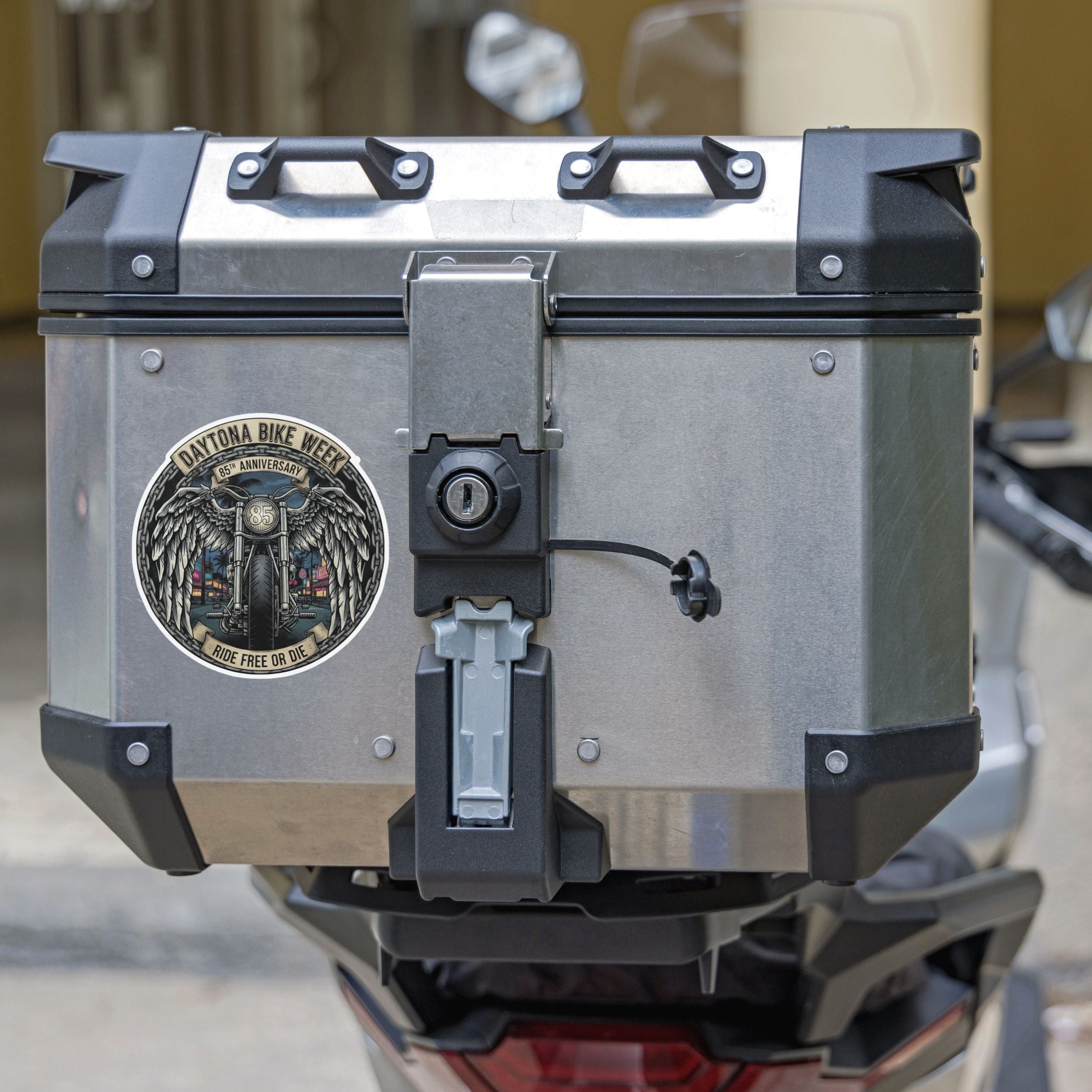 Motorcycle luggage box with a visible brand logo on a blurred background