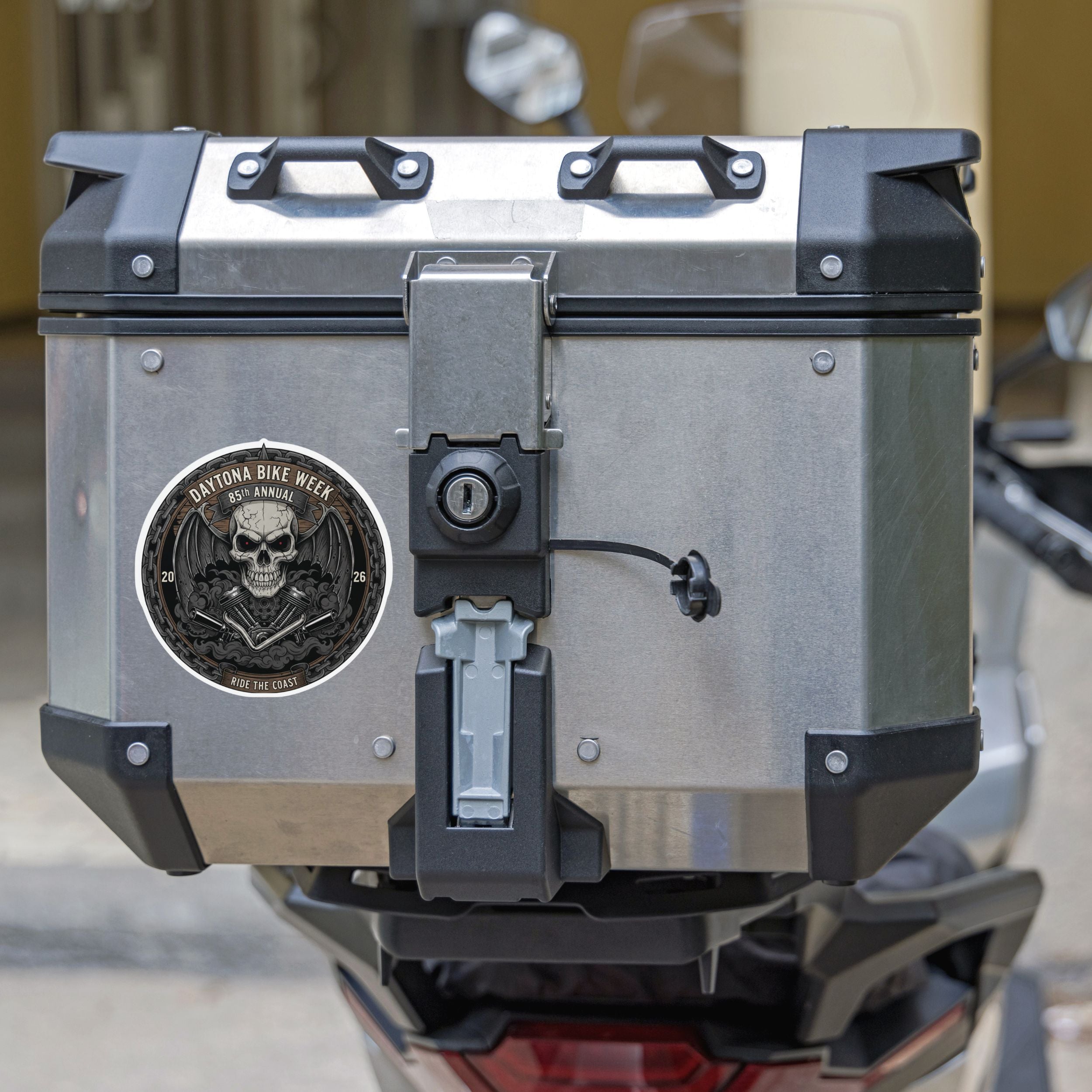 Motorcycle luggage box with a visible brand logo on a blurred background