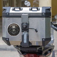 Motorcycle luggage box with a visible brand logo on a blurred background