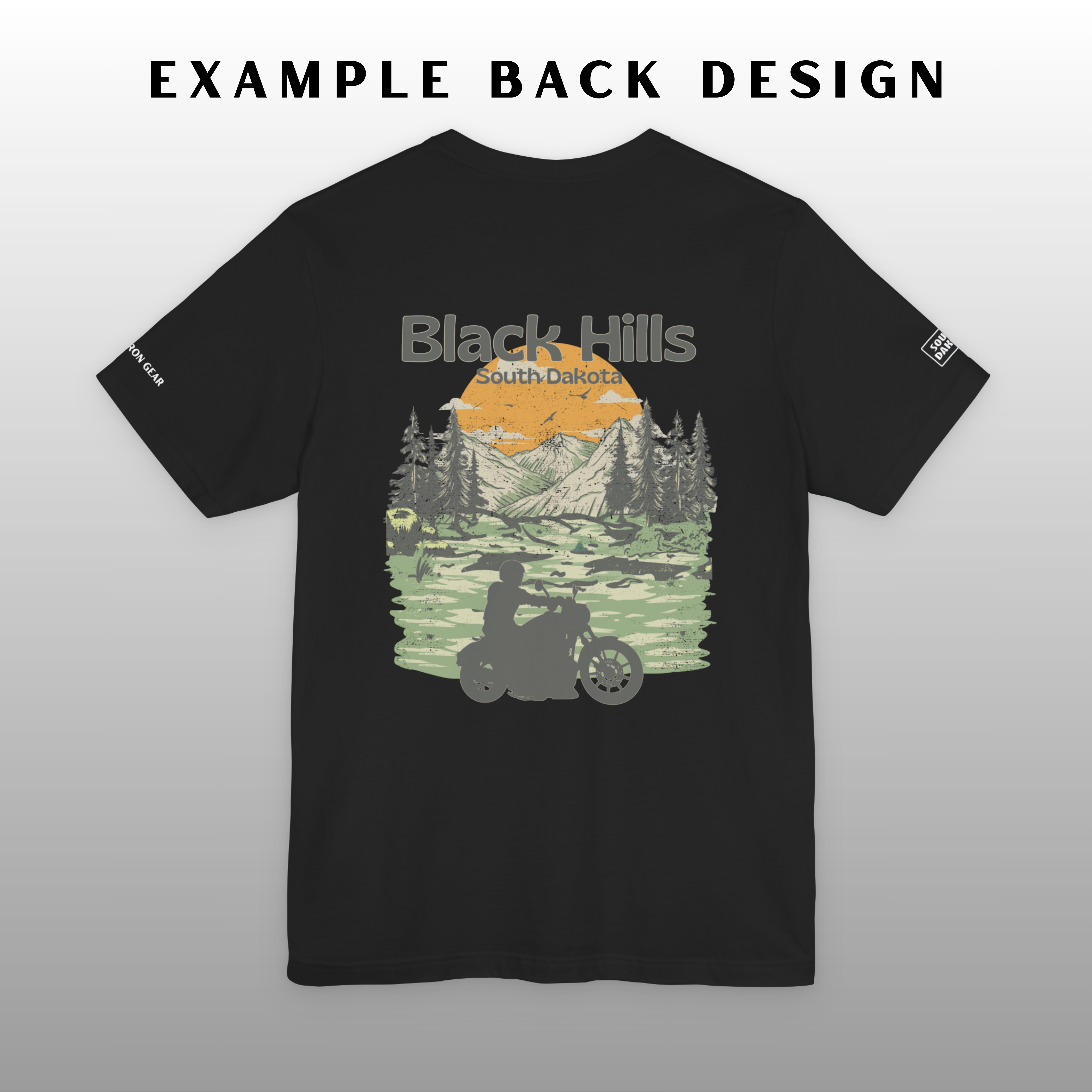 Black t-shirt with a scenic design of mountains and trees on a gray background