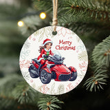 Circular Christmas ornament with a woman on a red motorcycle and 'Merry Christmas' text, hanging on a tree.