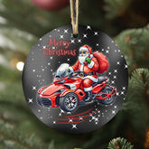 Christmas ornament with Santa Claus riding a red motorcycle on a gray background, hanging on a tree.