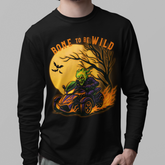 Man wearing a black long-sleeve shirt with a graphic design on a gray background