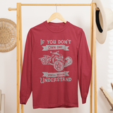 Red sweatshirt with graphic design on a wooden rack in a room setting.