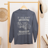Blue sweatshirt with graphic design on a wooden rack in a room setting.