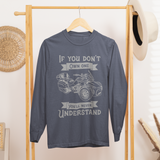 Blue sweatshirt with graphic design on a wooden rack in a room setting.