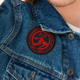 Man wearing a denim jacket with a red patch on a beige background