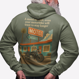 Person wearing a green hoodie with a graphic design on the back, featuring a motel and motorcycle.