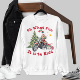 White sweatshirt with Christmas design and text, black jacket, white sneakers, and striped blanket on a white background