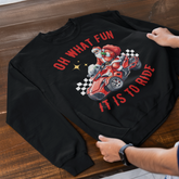 Black sweatshirt with a graphic design and text on a wooden surface