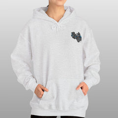 Person wearing a white hoodie with a small logo on a gray background