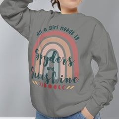 Person wearing a gray sweatshirt with a rainbow design and text on a plain background