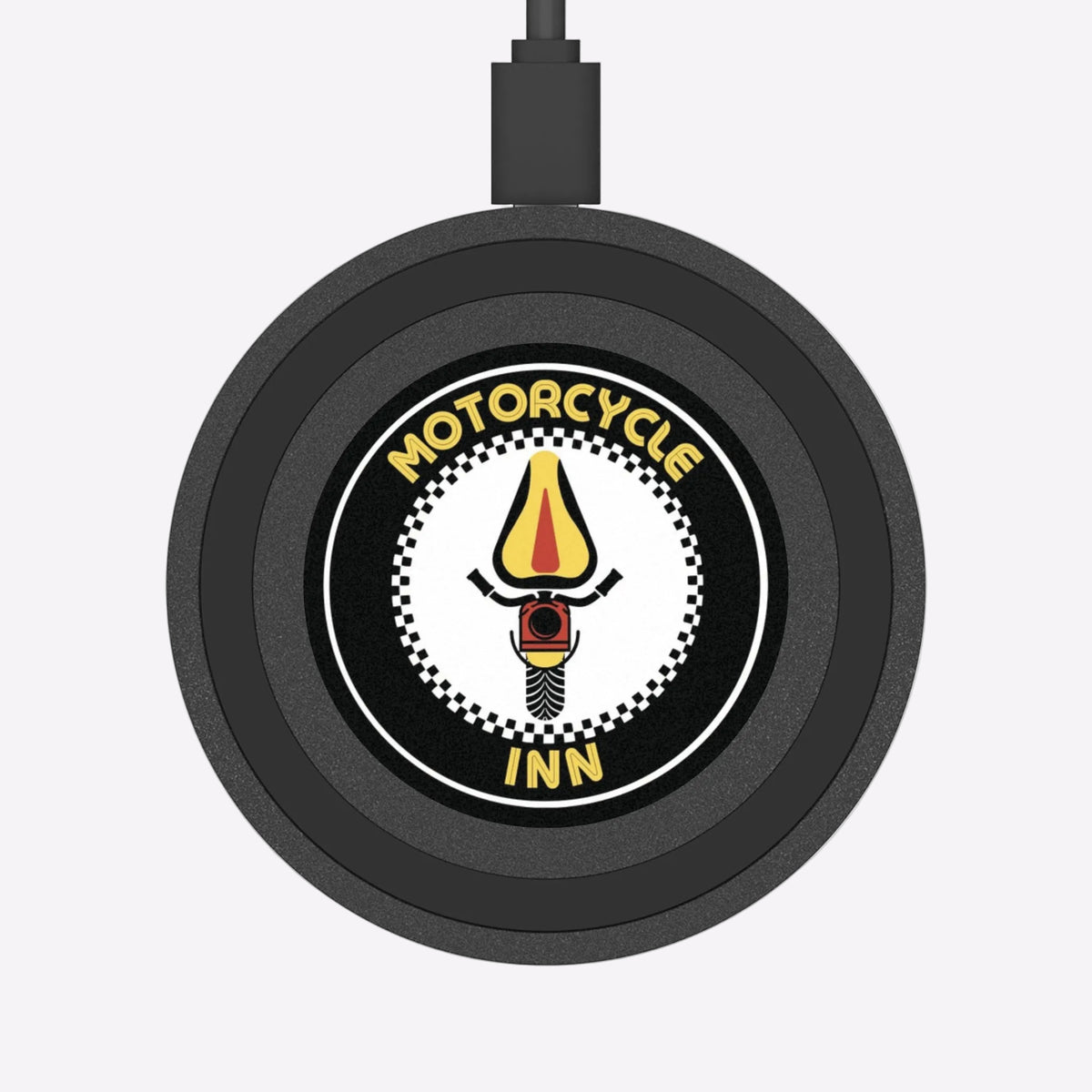 Round black sign with motorcycle graphic and 'Motorcycle Inn' text on a white background