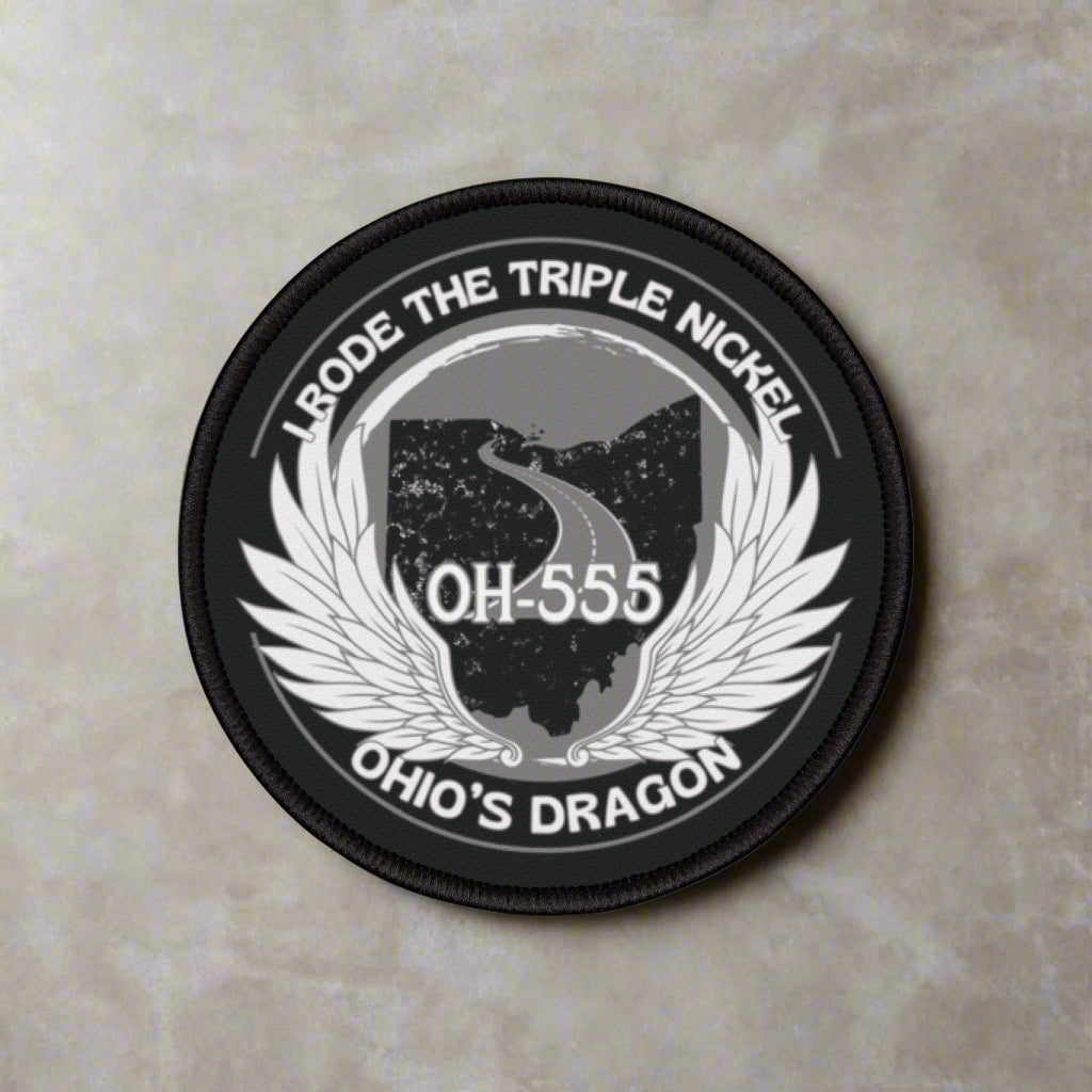 Round patch with text and wings design on a white background