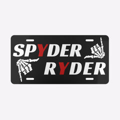 Black license plate with 'SPYDER RYDER' text and skeleton hand graphics on a white background