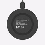 Black wireless charging pad with text and FCC logo on a white background