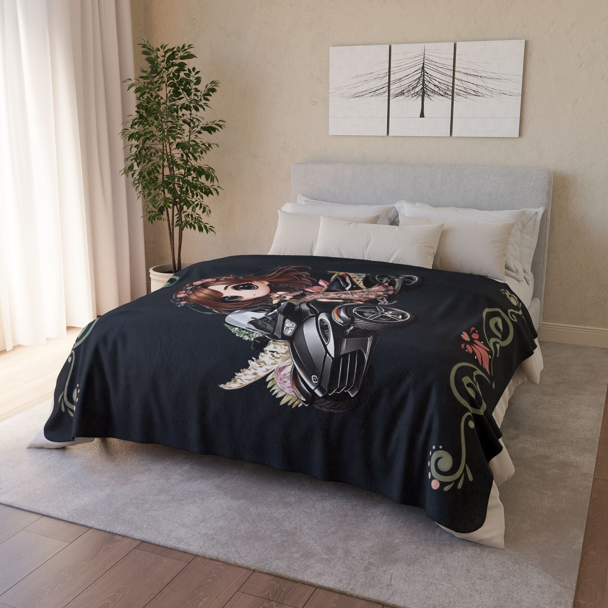 Bed with a black blanket featuring a motorcycle design in a bedroom setting.