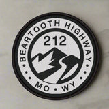 Round patch with 'Beartooth Highway 212 MO WY' text and mountain design on a white background