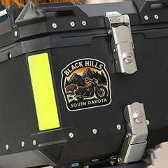 Black storage box with a 'Black Hills South Dakota' logo on a motorcycle.