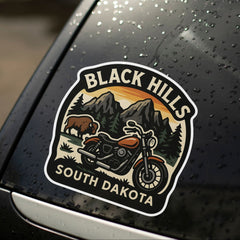 Decal of Black Hills, South Dakota on a car window with raindrops.