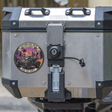 Motorcycle luggage box with a visible brand sticker on a blurred background