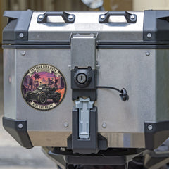 Motorcycle luggage box with a visible brand sticker on a blurred background