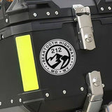 Black motorcycle storage box with a visible brand logo on a blurred background